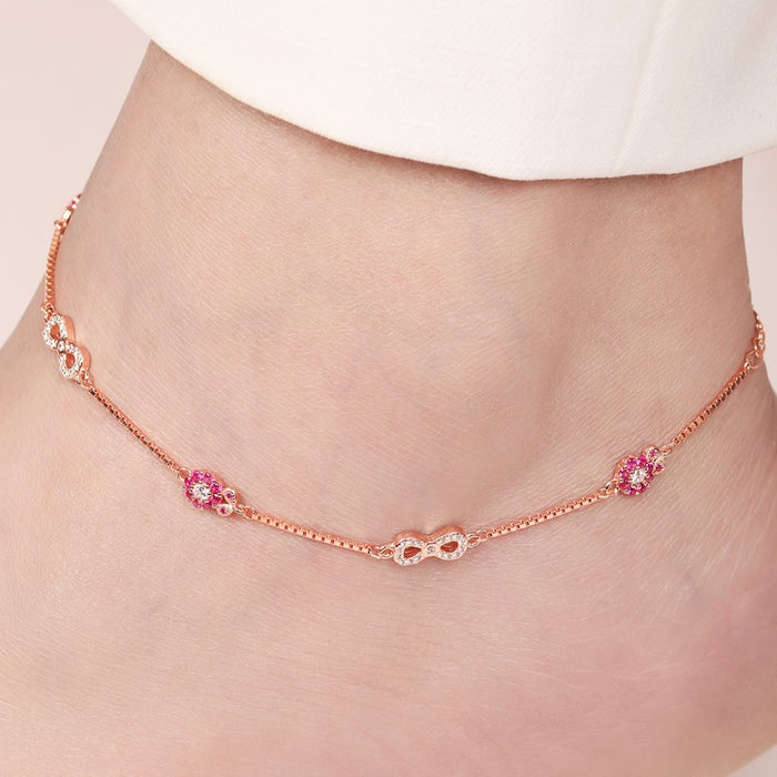 Rose gold 925 Sterling Silver anklet on a woman's ankle with infinity and pink floral CZ details. – Zavya