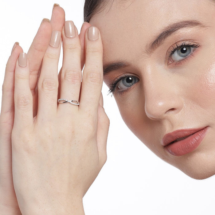 Woman resting hands by face, wearing a 925 Sterling Silver infinity couple ring. Silver rings for women – Zavya