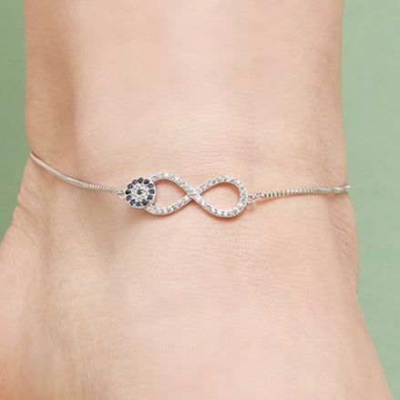 925 Sterling Silver infinity evil eye anklet with crystals on a woman's ankle. Jewellery for women – Zavya