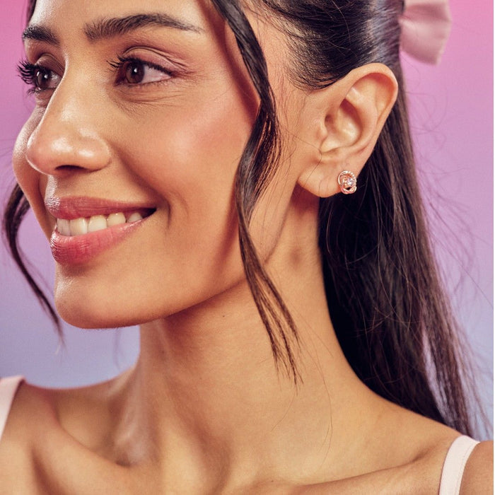 Smiling woman wearing 925 Sterling Silver rose gold stud earrings. Elegant women's jewellery – Zavya
