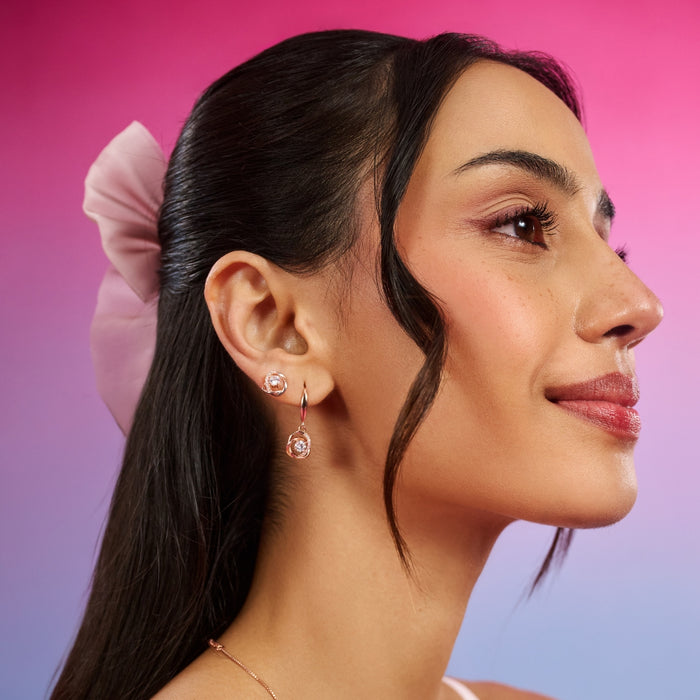 Smiling woman wearing 925 Sterling Silver rose gold stud earrings. Elegant women's jewellery – Zavya
