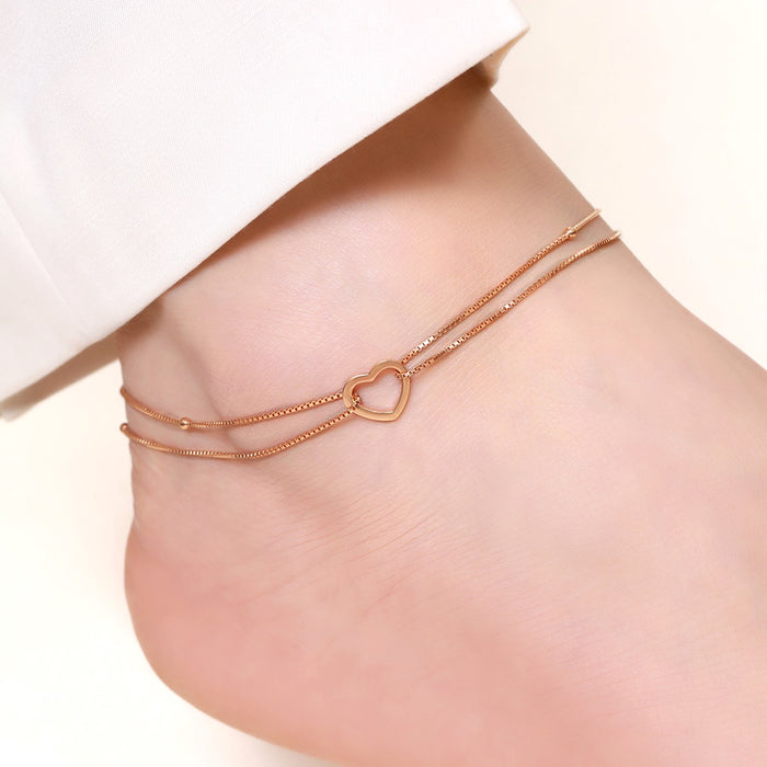 Dainty 925 Sterling Silver double chain heart anklet on a woman's ankle. Minimalist women's jewellery – Zavya