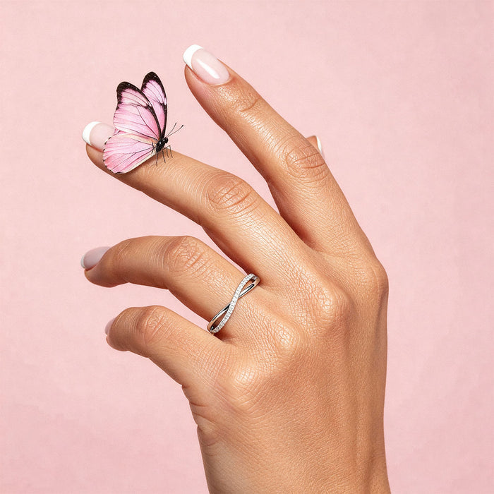 Hand wearing 925 Sterling Silver adjustable sparkle ring, pink butterfly on finger, pink background – Zavya