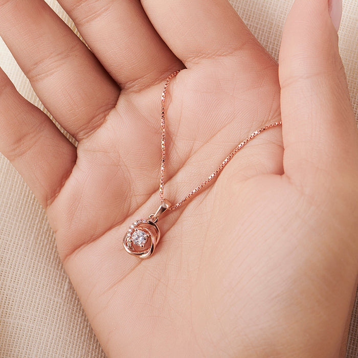 Rose gold 925 Sterling Silver necklace for women with sparkling pendant held in hand – Zavya