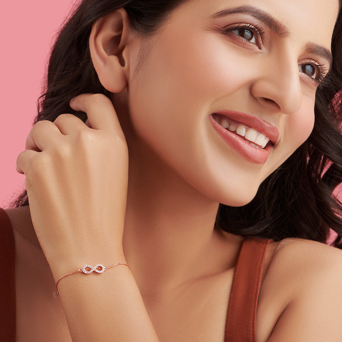 Smiling woman wearing a minimalist rose gold infinity 925 Sterling Silver bracelet. Women's jewellery – Zavya