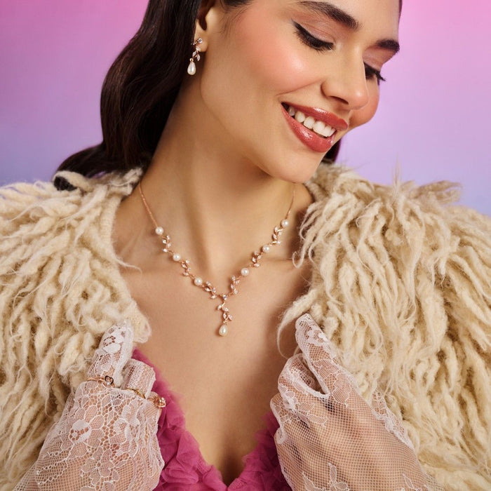 Smiling woman wearing a women's rose gold CZ 925 Sterling Silver pendant necklace. – Zavya
