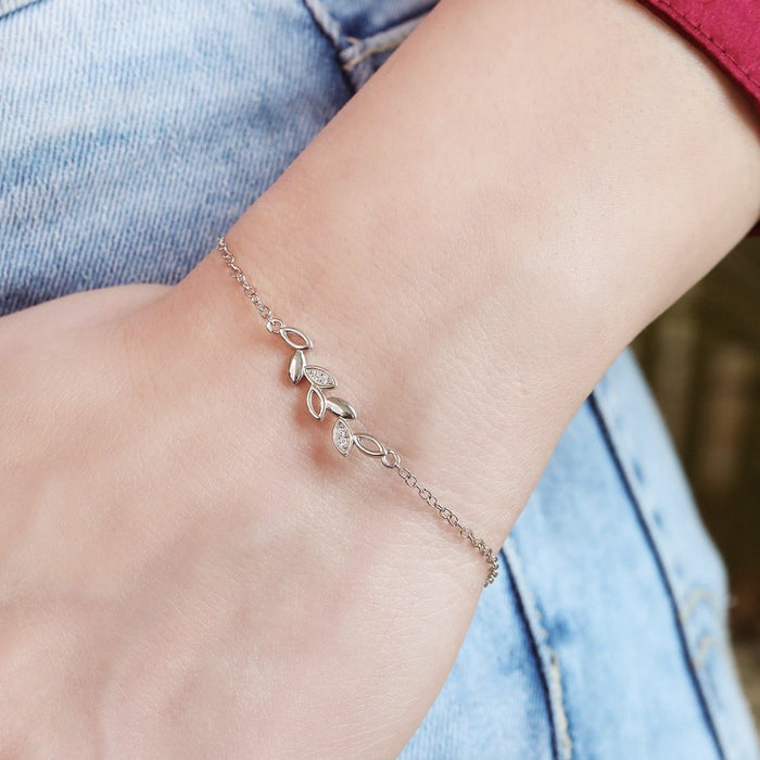 Woman wearing a delicate 925 Sterling Silver leaf bracelet with cubic zirconia. Silver jewelry for women – Zavya