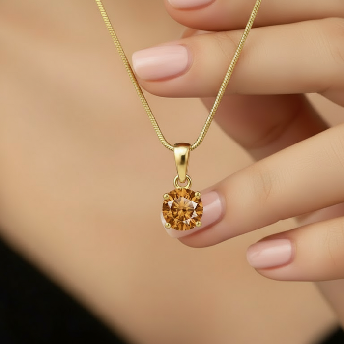 Woman holding a gold plated 925 Sterling Silver round solitaire pendant necklace on a snake chain – Zavya