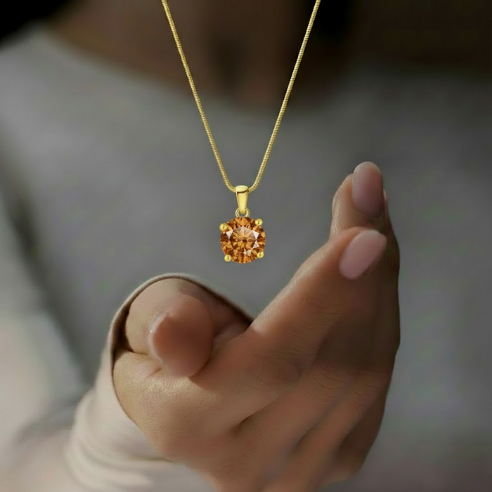 Woman wearing a gold plated 925 Sterling Silver solitaire pendant necklace on a snake chain – Zavya