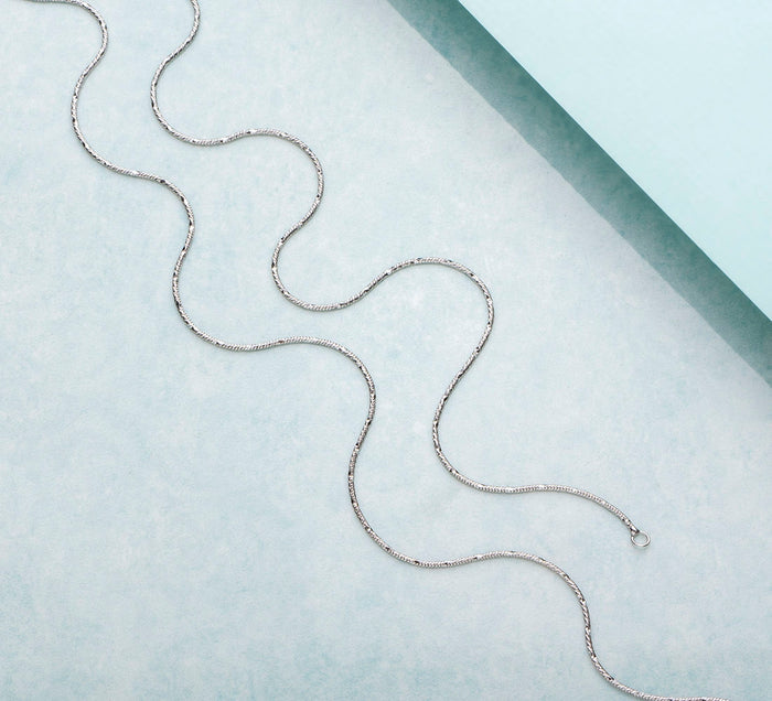 Wavy minimal chain 925 Sterling Silver anklet for women. Delicate everyday silver jewellery on light blue – Zavya
