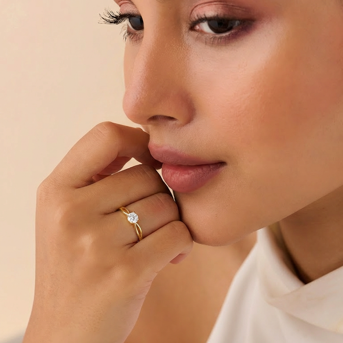 Woman wearing a gold plated 925 sterling silver solitaire ring. Minimal everyday jewellery for women. – Zavya