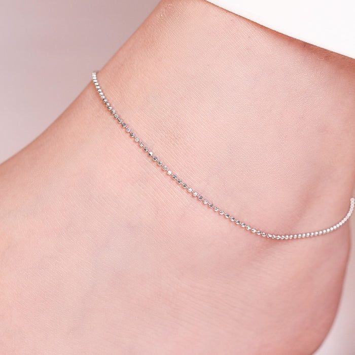 Minimalist 925 Sterling Silver anklet with tiny beads on a woman's ankle. Everyday jewelry for women – Zavya