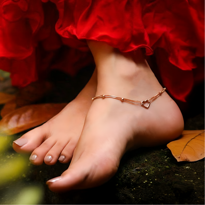 Woman's bare feet wearing a dainty 925 Sterling Silver heart anklet. Beautiful women's jewellery – Zavya