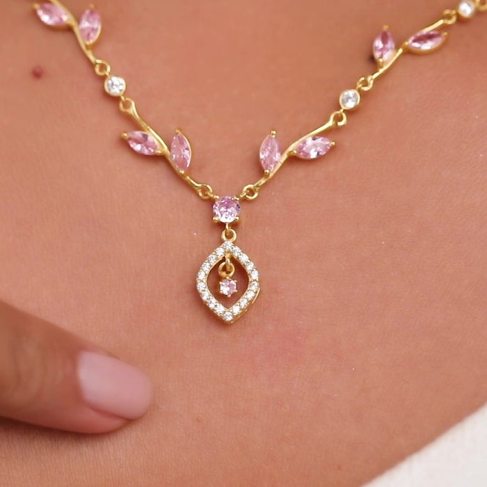 Woman wearing a gold plated 925 Sterling Silver necklace with pink blossom stones and crystal pendant – Zavya