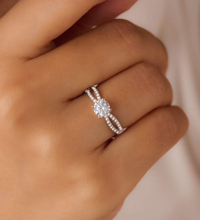 Woman wearing a 925 Sterling Silver adjustable solitaire ring with a sparkling crystal split band. – Zavya