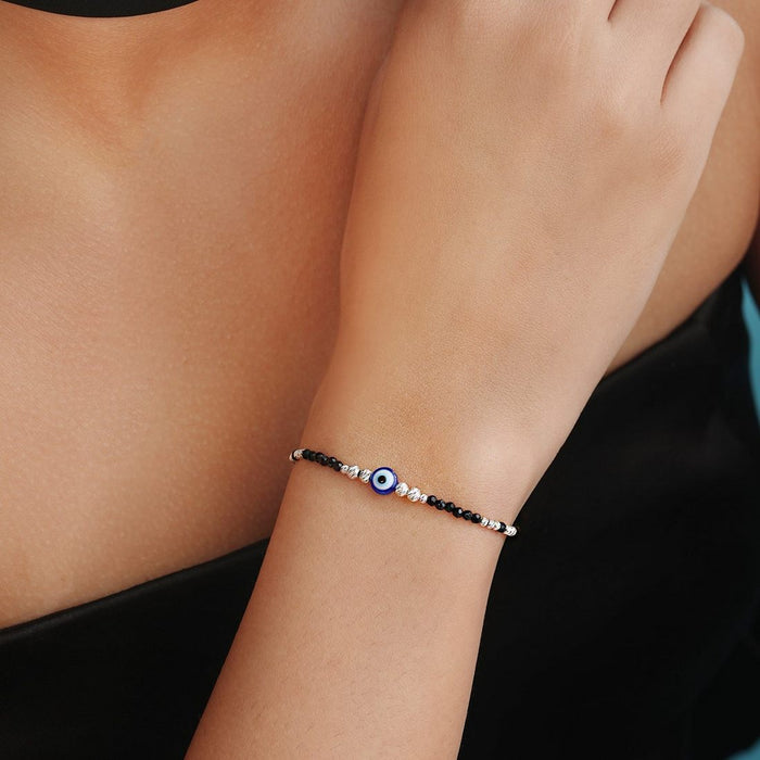 Woman wearing a 925 Sterling Silver evil eye beaded bracelet. Protective women's jewellery – Zavya