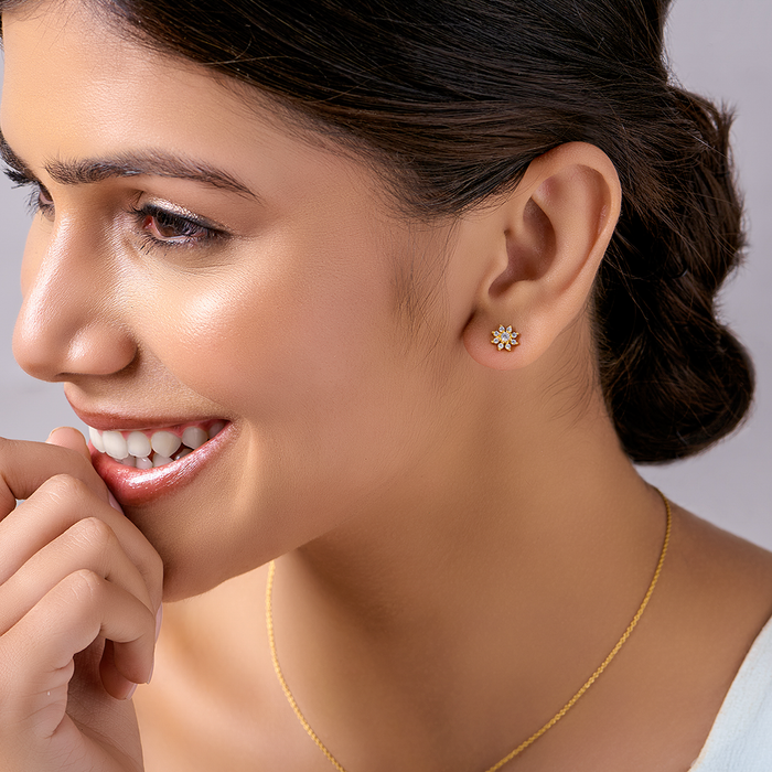 Smiling woman in floral gold 925 Sterling Silver stud earrings. Cubic zirconia women's jewelry – Zavya