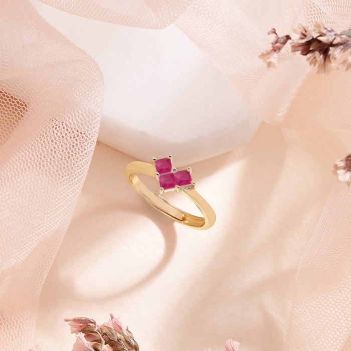 Women's rose-gold plated 925 Sterling Silver ruby heart ring on a white stone and pink fabric. – Zavya