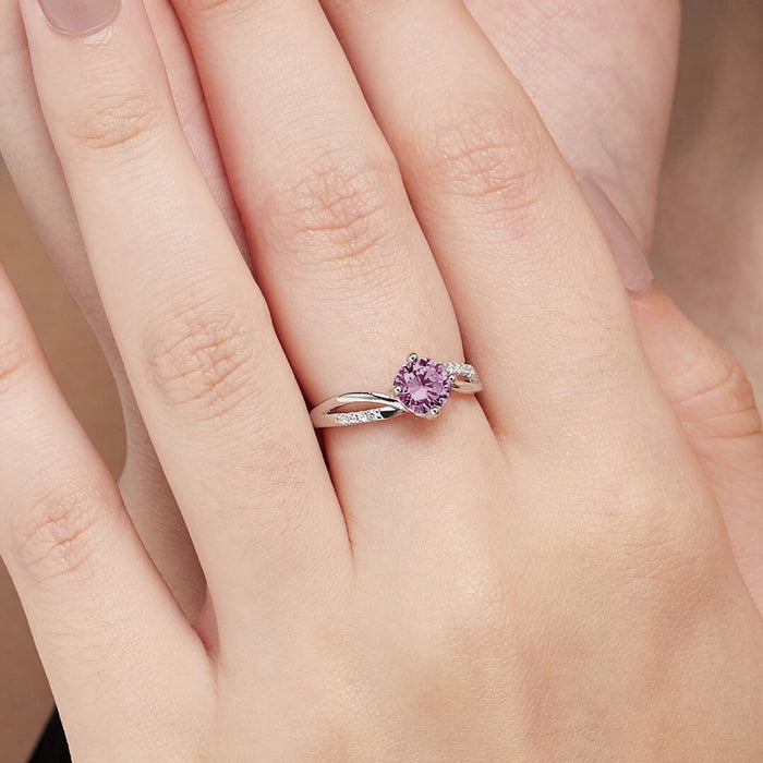 Woman's hand wearing a pink solitaire 925 Sterling Silver ring. Elegant gemstone jewelry for women – Zavya