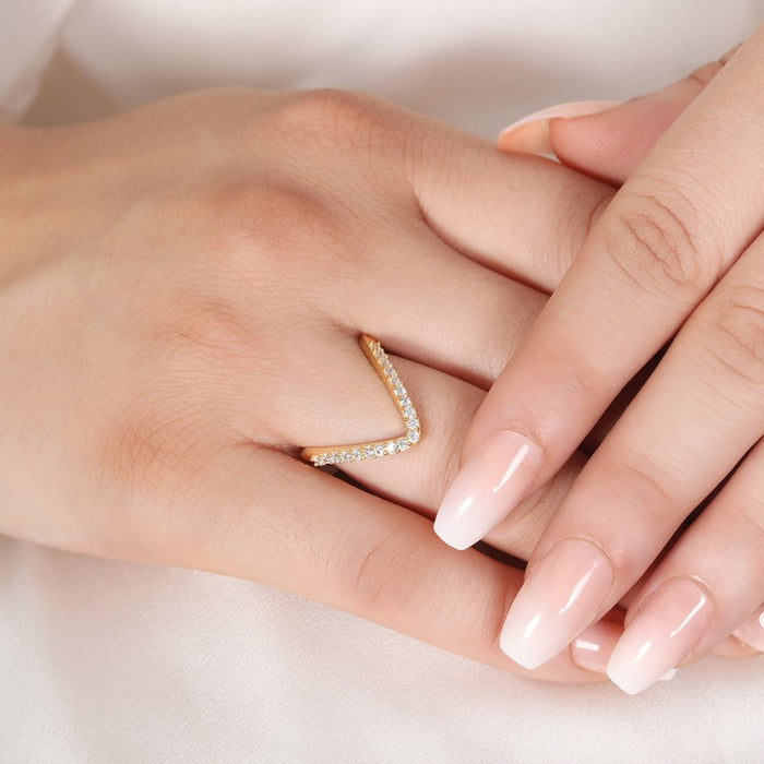 Woman's hand wearing a stone-studded gold plated 925 Sterling Silver Vanki ring. Women's jewellery – Zavya