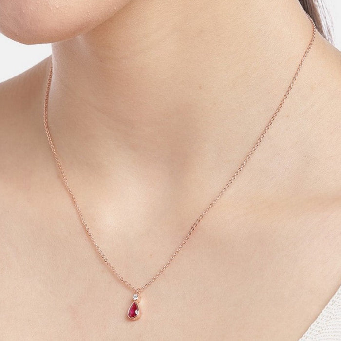 Woman wearing a rose gold plated 925 Sterling Silver necklace with ruby teardrop pendant. Women's jewelry – Zavya