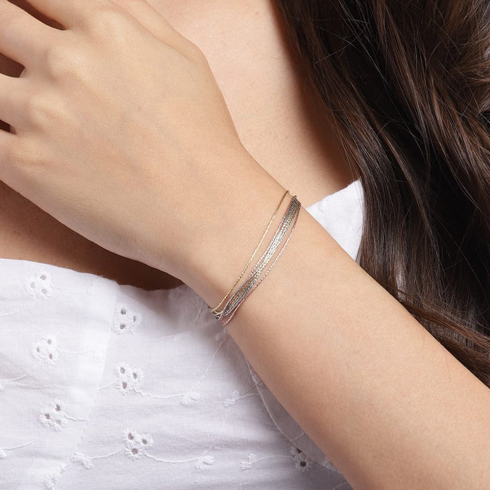 Woman wearing a multi-chain triple tone 925 Sterling Silver bracelet. Layered jewellery for women – Zavya