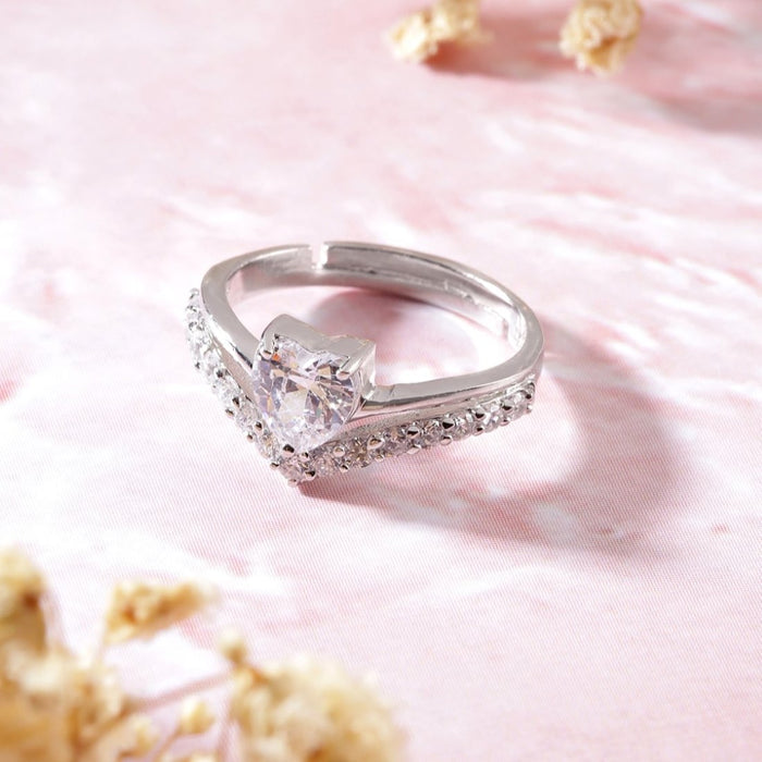 Adjustable 925 Sterling Silver heart CZ ring for women on a pink marble surface – Zavya