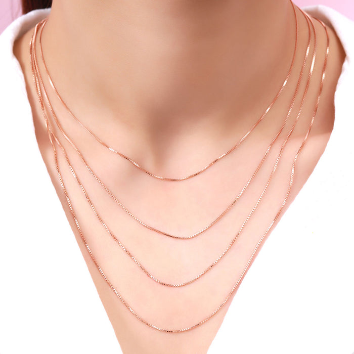 Woman wearing a layered gold plated 925 Sterling Silver box chain necklace. Modern women's jewelry. – Zavya