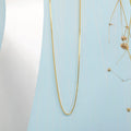 Sleek gold plated 925 Sterling Silver box chain necklace for women on a light blue background – Zavya