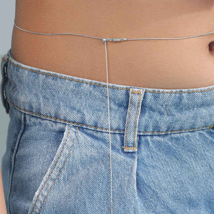 Woman wearing a 925 Sterling Silver sliding waist chain over jeans. Silver belly chain jewellery for women – Zavya
