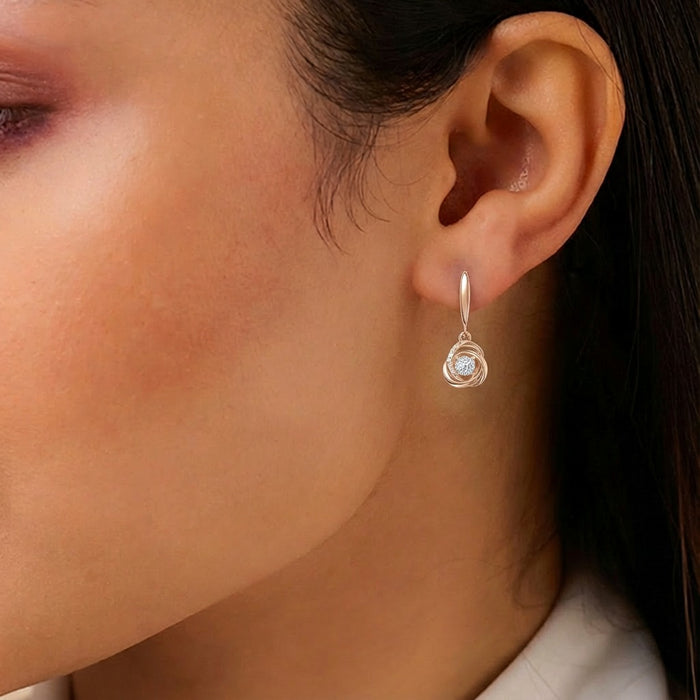 Woman wearing 925 Sterling Silver rose gold drop earrings with a central stone. Jewellery for women – Zavya