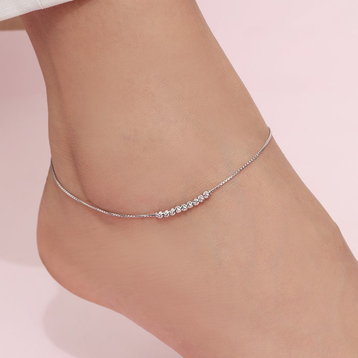 Woman's ankle wearing a delicate 925 Sterling Silver box chain anklet, fine jewelry for women. – Zavya