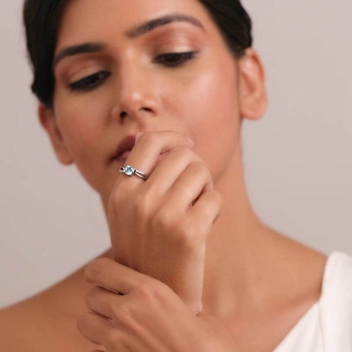 Woman wearing a blue CZ 925 Sterling Silver adjustable ring. Elegant silver jewelry for women. – Zavya