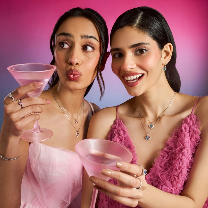 Women holding pink drinks wearing 925 Sterling Silver Heart of the Sea necklaces. Silver jewelry for women – Zavya