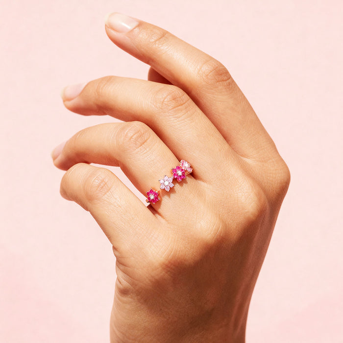 Woman's hand wearing an adjustable 925 Sterling Silver rose gold ring with pink flowers for women – Zavya