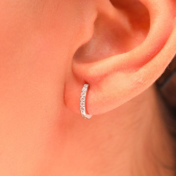 Woman wearing sparkling 925 Sterling Silver hoop earrings. Elegant everyday jewelry for women. – Zavya
