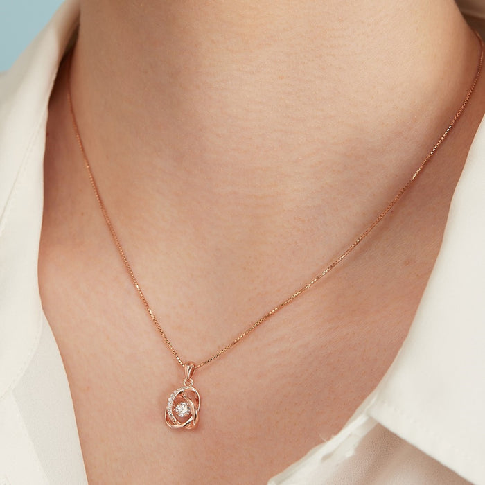 Woman wearing a rose gold 925 Sterling Silver necklace with intertwined stone pendant. Women's jewellery – Zavya