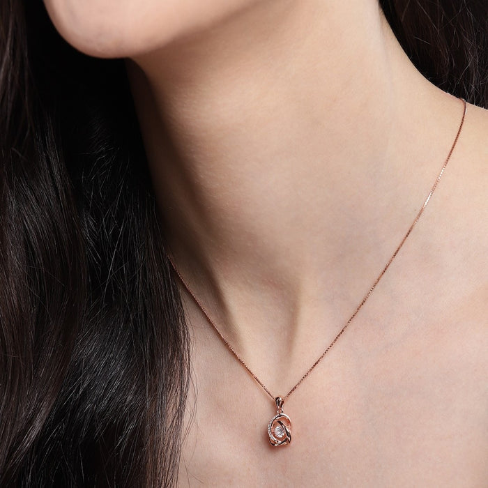 Woman wearing a rose gold 925 Sterling Silver necklace with an intertwined crystal pendant. – Zavya