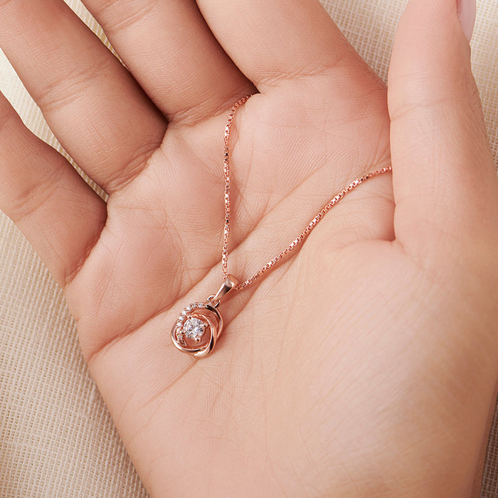 Woman's hand holding a rose gold 925 Sterling Silver crystal pendant necklace. Fine jewelry for women – Zavya