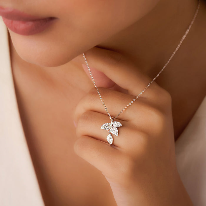 Woman touching a 925 Sterling Silver leaf pendant necklace. Rhodium plated jewellery for women – Zavya