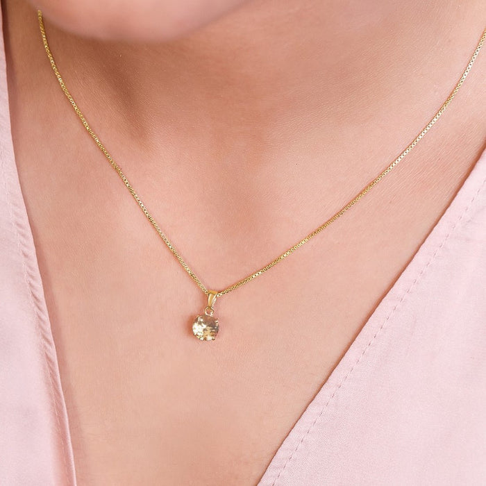 Woman wearing a gold plated 925 Sterling Silver solitaire pendant and chain. Elegant women's jewellery – Zavya