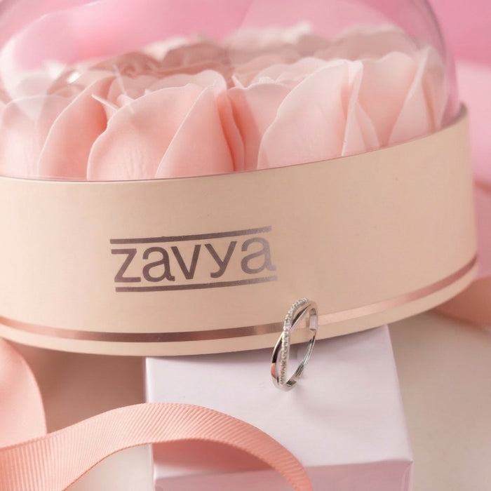 Sparkling 925 Sterling Silver adjustable ring for women leaning on a pink rose gift box. – Zavya