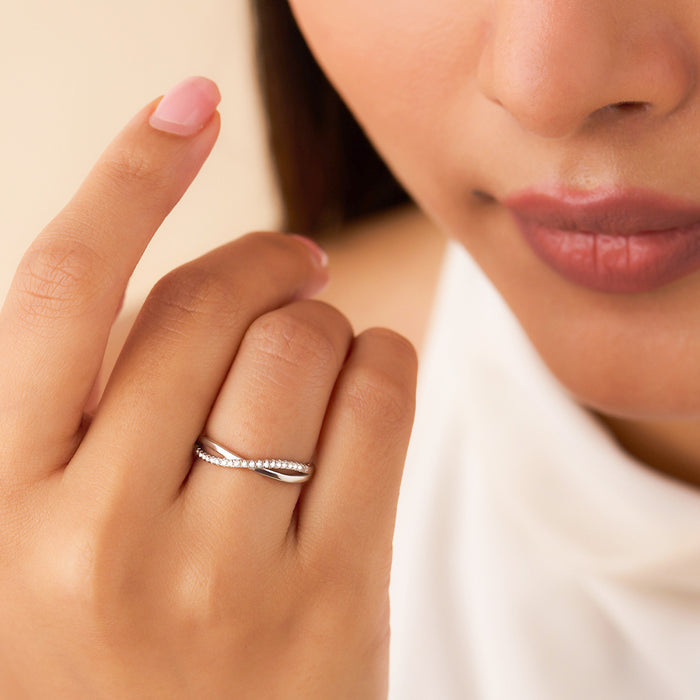 Woman wearing 925 Sterling Silver Infinite Sparkle criss-cross ring with stones – Zavya