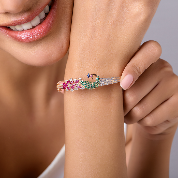 Close-up on wrist of women's 925 Sterling Silver rose gold peacock bracelet with colorful stones – Zavya