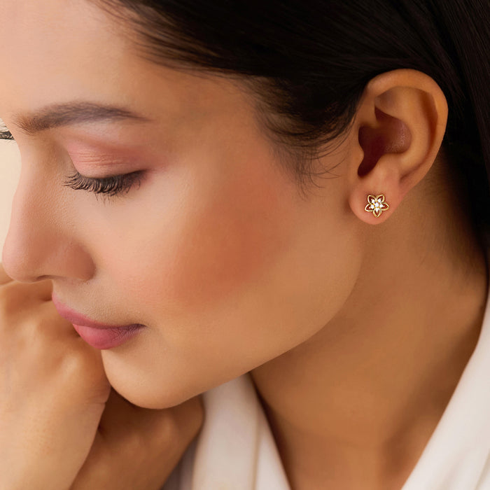 Woman wearing gold plated floral stud earrings in 925 sterling silver. Everyday jewelry for women. – Zavya