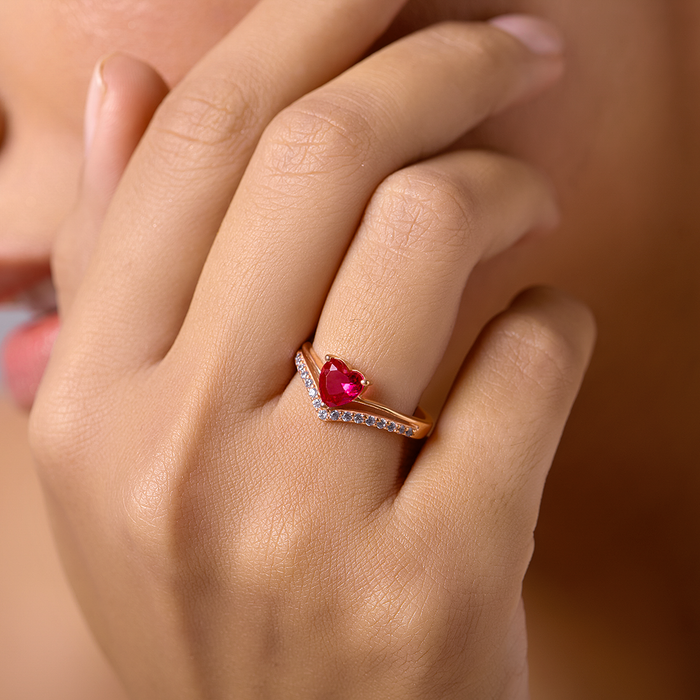Hand wearing a pink heart rose gold plated 925 Sterling Silver ring with a studded curved band – Zavya